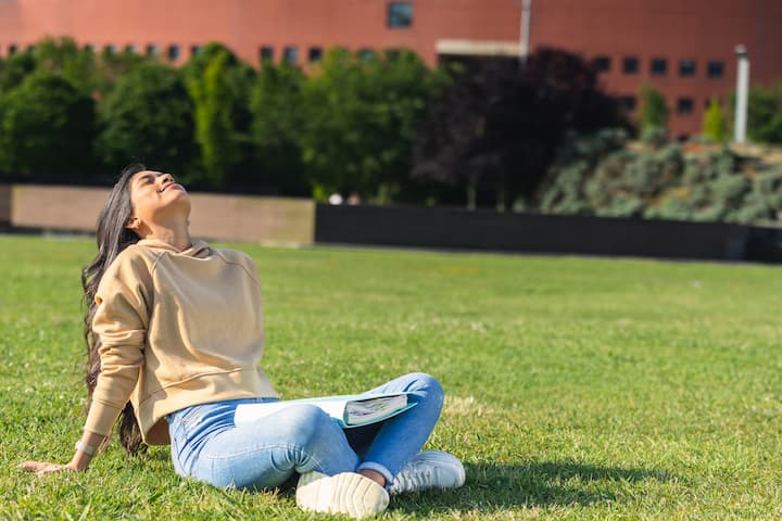 Stress-free woman sitting in a park