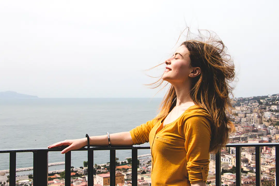 Woman looking relieved holding a railing